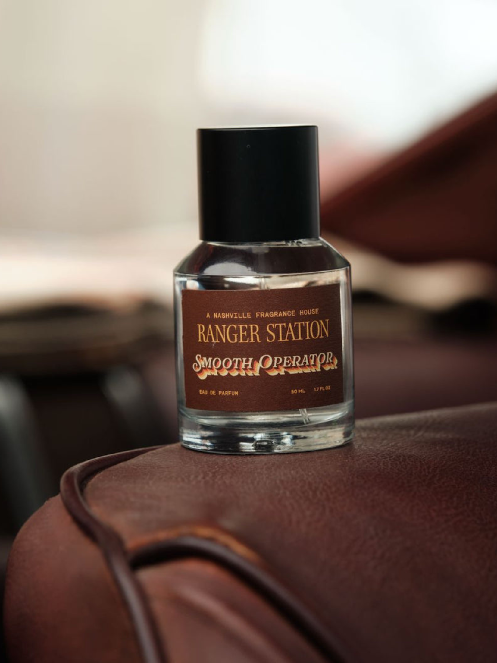 Ranger Station Eau de Parfum in Smooth Operator Scent 50mL bottle on a chair
