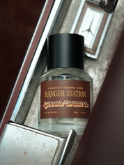 Ranger Station Eau de Parfum in Smooth Operator Scent 50mL bottle in a car