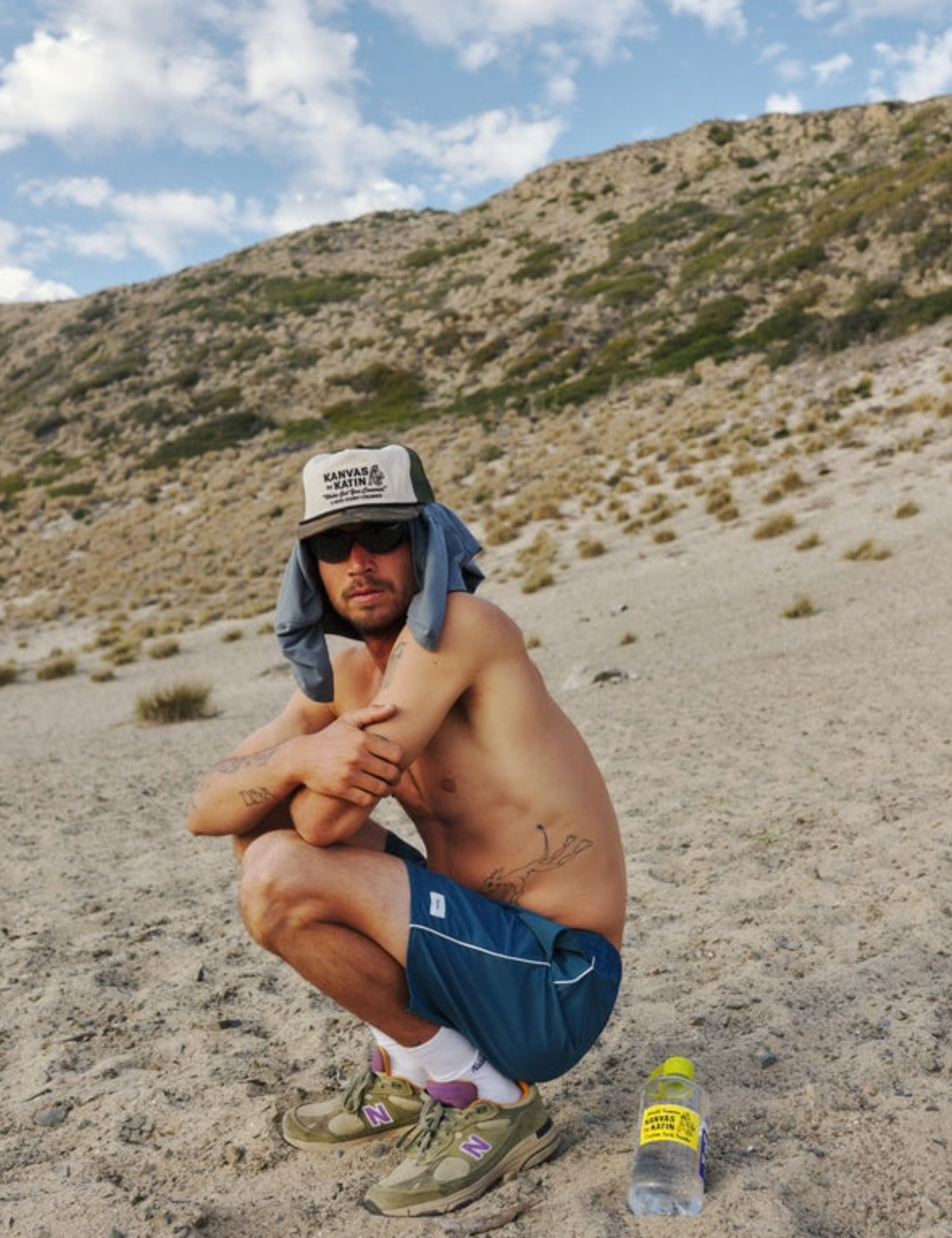 Katin Service Trucker Hat Camo Print on bill green Mesh on Back lifestyle of model on beach