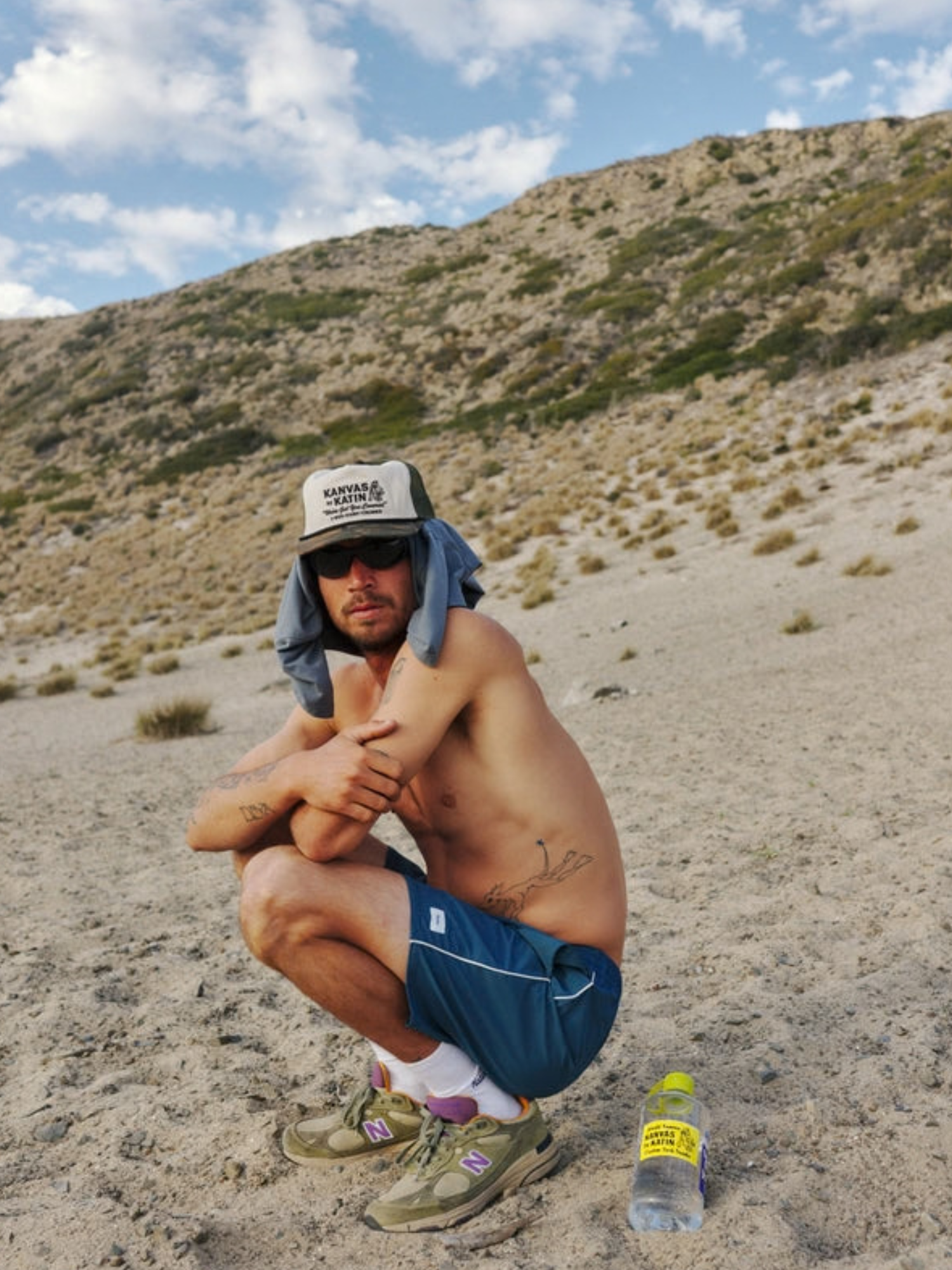 Katin Service Trucker Hat Camo Print on bill green Mesh on Back lifestyle of model on beach